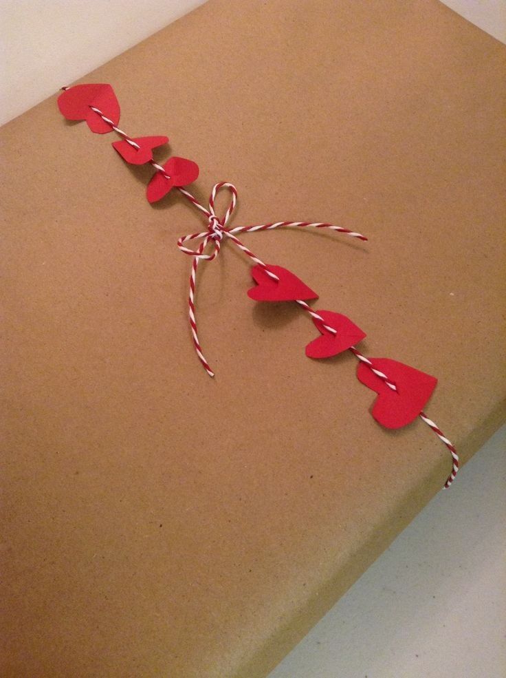 a brown box with red hearts tied to it