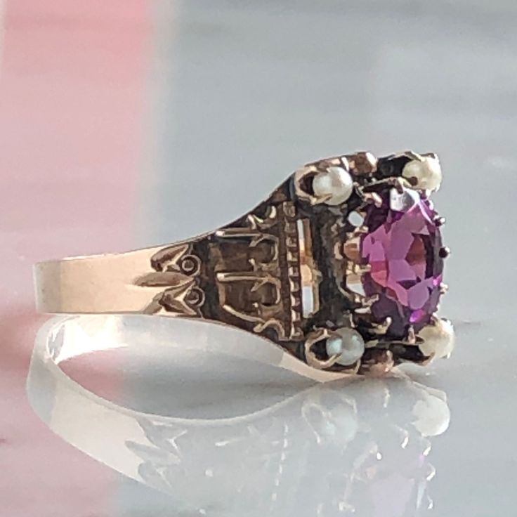 Details: Beautiful Victorian Garnet and Seed Pearl ring set in lovely 14K rose gold. The band is adorned in lovely abstract filigree engraving. The stone has great depth, and has a lovely rich pink tint to the garnet. It is surrounded by 4 seed pearls. The garnet measures 7.5mm x 5mm. There are no internal markings. Measurements: Ring measures a size 7 3/4 US. It can be re-sized for a fee. Condition: The overall all condition of this ring is very good. Please ask all questions prior to placing a Victorian Hallmarked Rose Gold Ruby Ring, Victorian Rose Gold Ruby Ring Hallmarked, Antique Pink Jewelry With Rose Cut Diamonds, Antique Pink Rose Cut Diamond Jewelry, Victorian Pink Rose Cut Diamond Jewelry, Elegant Pink Jewelry With Engraving, Pink Rings With Intricate Design For Anniversary, Elegant Engraved Pink Jewelry, Elegant Pink Engraved Jewelry