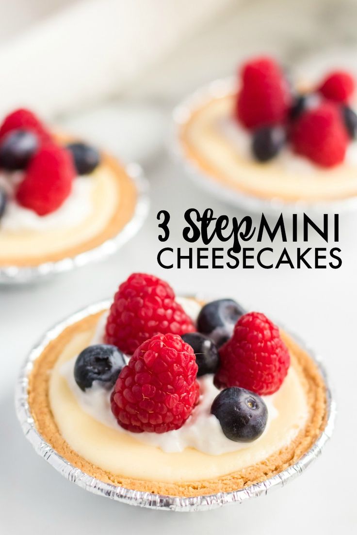 three mini cheesecakes with fresh berries on top