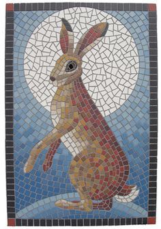 a mosaic with a rabbit on it's back and the moon in the background