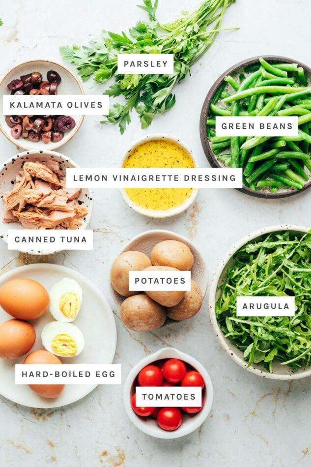 the ingredients for green beans are shown in bowls on a white counter top, including eggs, tomatoes, broccoli, and other vegetables