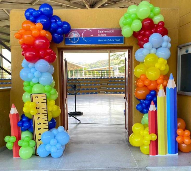 an entrance decorated with balloons and pencils