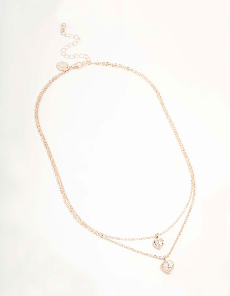 Dazzle with this Rose Gold Diamante Heart Layered Necklace. With its captivating heart pendant, it's perfect for layering or wearing solo for that head-turning glamour. A must-have accessory for any outfit. Material: Crystal Dimensions: Chain Length: 45 cm Extender: 8 cm Feature Dimensions: Pendant Width 9 mm x Pendant Height 14 mm | Lovisa Rose Gold Diamante Heart Layered Necklace, Clear Layered Necklace, Chain Lengths, Layered Necklaces, Chain Length, Heart Pendant, Turning, Layering, Rose Gold, Chain