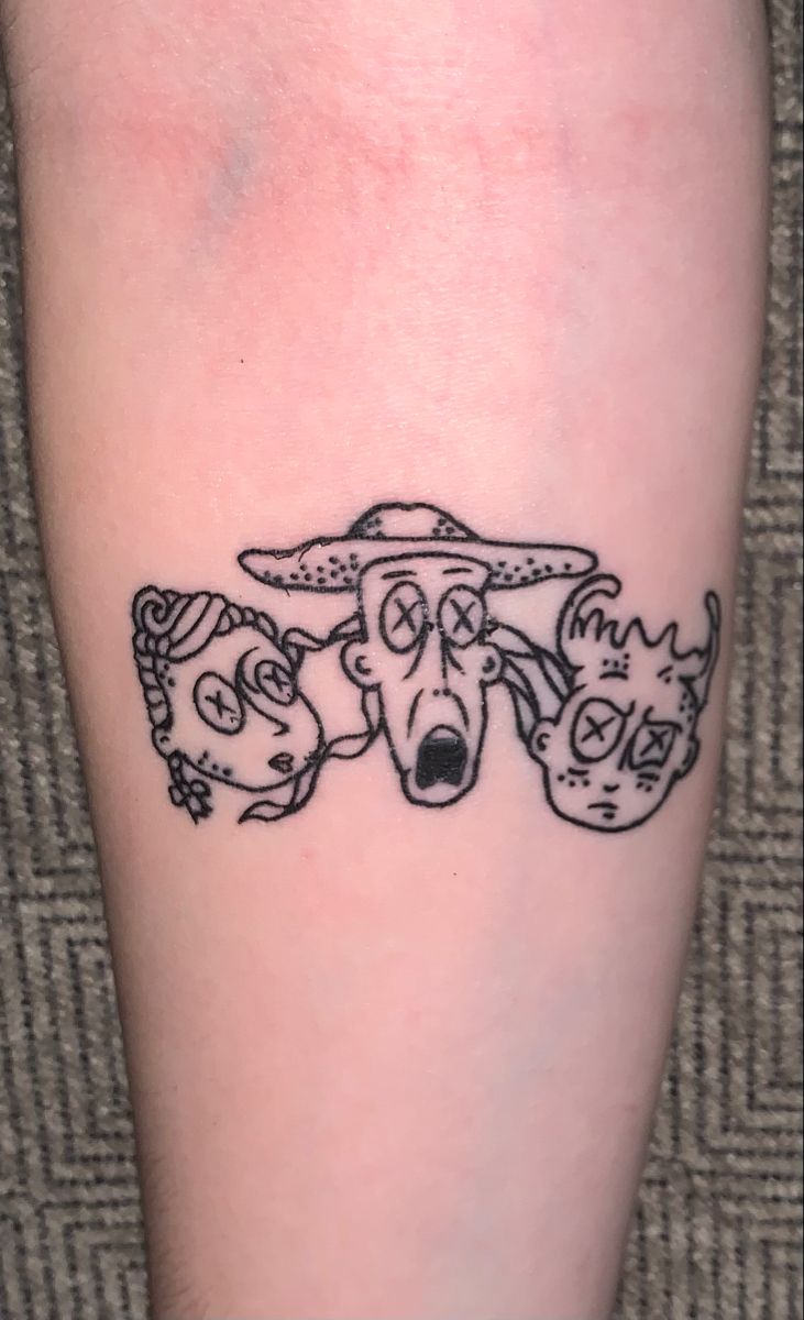 a tattoo on the leg of a person with three dogs wearing hats and holding their heads together