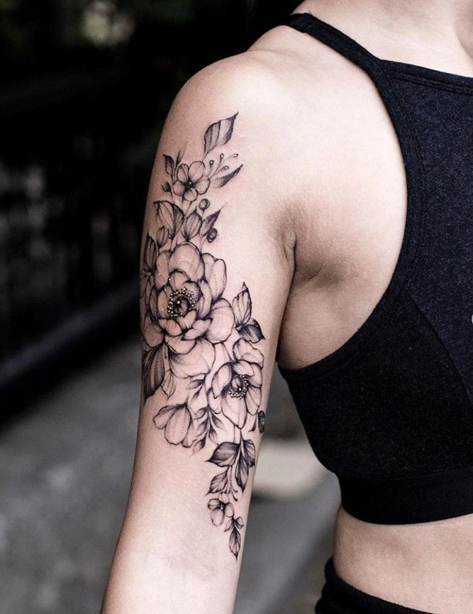 a woman with a flower tattoo on her arm