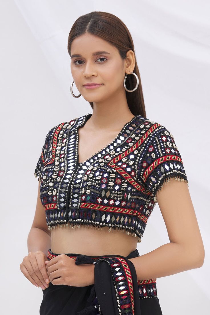 Black saree blouse with all-over mirror  embellishments, shell hand work and multi-coin tassels.
Component: 1
Embroidered
Neckline: V Neck
Sleeve Length: Half
Fabric: Munga Silk
Color: Black
Note: Saree worn by the model is not for sale - Aza Fashions Festive V-neck Choli With Mirror Work, Navratri Rituals Blouse With Zari Work, Festive Ritual Blouse With Zari Work, Festival Rituals Blouse With Zari Work, Bollywood Style V-neck Blouse With Mirror Work, Traditional Diwali Blouse For Rituals, Traditional Blouse For Diwali Rituals, Bollywood Style Blouse For Diwali Rituals, Diwali V-neck Blouse With Mirror Work