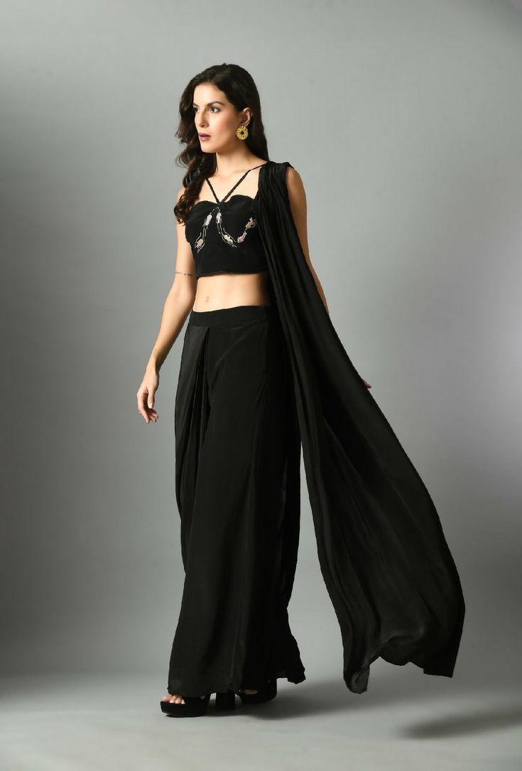 The Nur Bustier with Moonshine pre draped saree is a luxurious statement piece, crafted with fine crepe silk and our pre-draped saree in black and it is elegant and fuss-free and detailed embroidery on bustier. The black color adds a stylish twist to any look and the silk provides a lightweight feel with long-lasting comfort.Composition and care Crepe silk Hand wash or dry clean only GARMENT MEASUREMENTS Size Bust Waist Hip Neck Shoulder Arm Hole XS 32” 26” 35” 13” 14” 13” S 34” 28” 37” 13.5” 14.5” 14” M 36” 30” 39” 14.5” 15” 15” L 38” 32” 41” 15.5” 15.5” 16” XL 40” 34” 43” 16.5” 16 17” Ships Worldwide from India.MADE IN INDIA Designer Black Draped Saree, Pre-draped Side Open Saree For Party, Black Georgette Draped Saree, Black Draped Georgette Saree, Traditional Black Draped Saree, Fitted Black Draped Saree, Party Pre-draped Saree With Cape Sleeves, Black Draped Saree With Sheer Dupatta, Elegant Draped Choli With Draped Sleeves