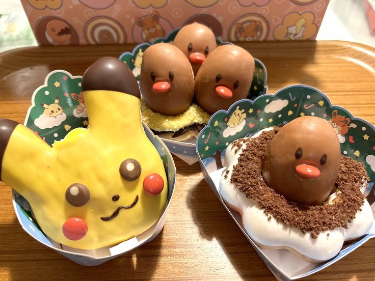 three desserts with chocolate and marshmallow toppings in bowls on a table