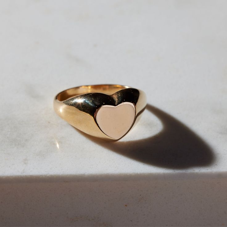 The timeless Girlfriend Signet Ring combines classic sophistication with playful spirit. The curved thick band is molded to a statement heart shape, which offers a refined aesthetic sure to be admired. The 18-karat gold filled ring is electroplate finished to provide a luxe and long-lasting finish, able to withstand water and more! Classic Open Ring Jewelry For Valentine's Day, Gold Heart Ring For Everyday Fine Jewelry, Everyday Gold Heart Ring Fine Jewelry, Yellow Gold Tarnish Resistant Heart Ring, Everyday Gold Heart Ring In Fine Jewelry Style, Tarnish Resistant Yellow Gold Heart Ring, Fine Jewelry Gold Heart-shaped Engraved Ring, Gold Heart-shaped Engraved Ring Fine Jewelry, Fine Jewelry Gold Engraved Heart Ring