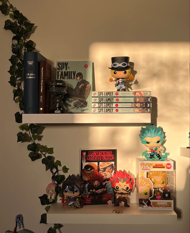 two shelves filled with books and figurines on top of each other next to a plant