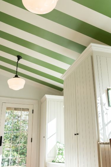 a kitchen with green and white stripes painted on the ceiling