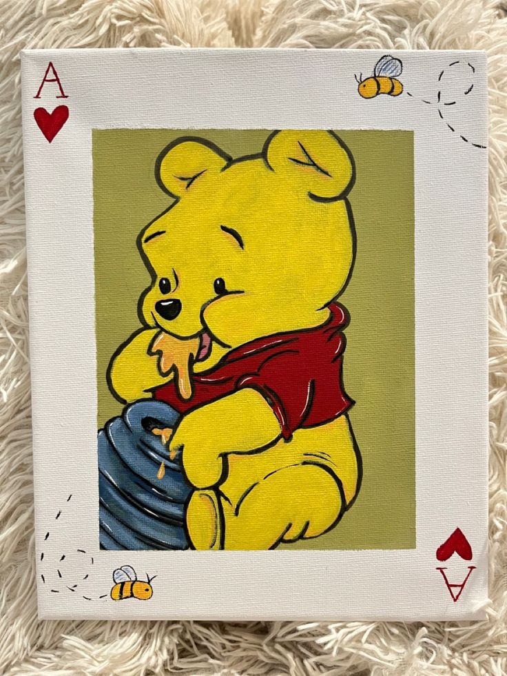 a painting of a yellow teddy bear with a red shirt on sitting in front of a playing card