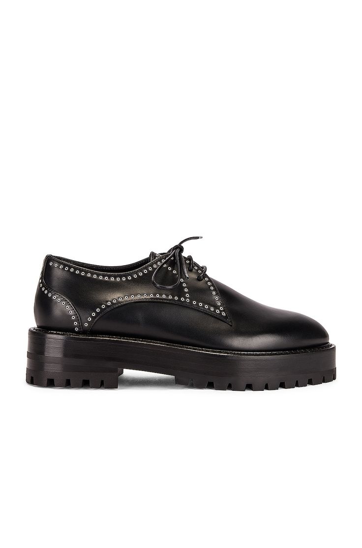 Find ALAÏA Eyelet Derby Loafers In Black on Editorialist. ALAÏA Eyelet Derby Loafers in Black Smooth calfskin leather upper with rubber sole. Made in Italy. Lace-up front. Goat leather lining. Brass eyelet detail throughout. Lug sole. Almond toe. Approx 25mm/ 1 inch platform Approx 40mm/ 1.5 inch heel. ALIA-WZ32. AA3D001CK008. About the designer: The late Azzedine Alaïa had a comprehensive understanding of the female form, thanks to an education in sculpture from École des Beaux-Arts. Revered for his bodycon silhouettes that defined the aesthetic of Paris in the ‘80s, the Tunisian designer was also known for his intricate footwear, statement bags and laser-cut accessories. Luxury Leather Shoes With Vibram Sole For Work, Luxury Leather Work Shoes With Vibram Sole, Black Leather Platform Loafers With Vibram Sole, Leather Dress Shoes With Studded Rubber Outsoles For Business, Calf Leather Loafers With Vibram Sole, Calf Leather Lace-up Shoes With Vibram Sole For Work, Calf Leather Lace-up Shoes With Lug Sole For Workwear, Calf Leather Loafers With Vibram Sole And Round Toe, Black Oxfords With Studded Rubber Outsoles For Work