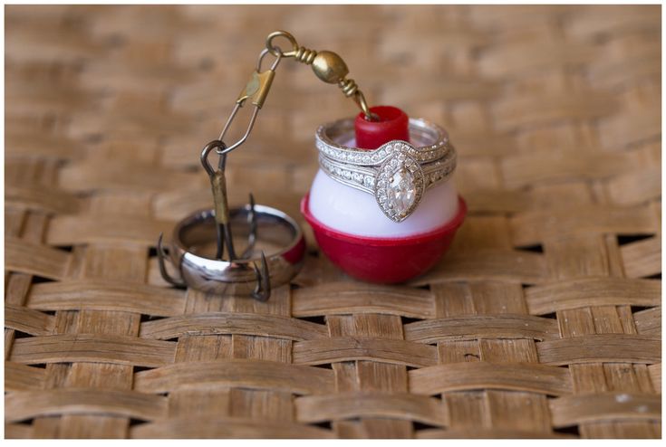 a small red and white container with a ring on it