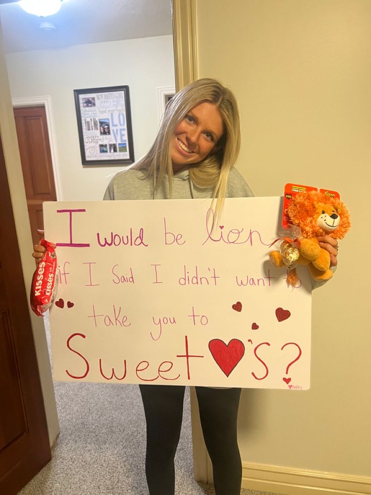 a woman holding a sign that says i would be ben if i said i didn't want to take you to sweets?