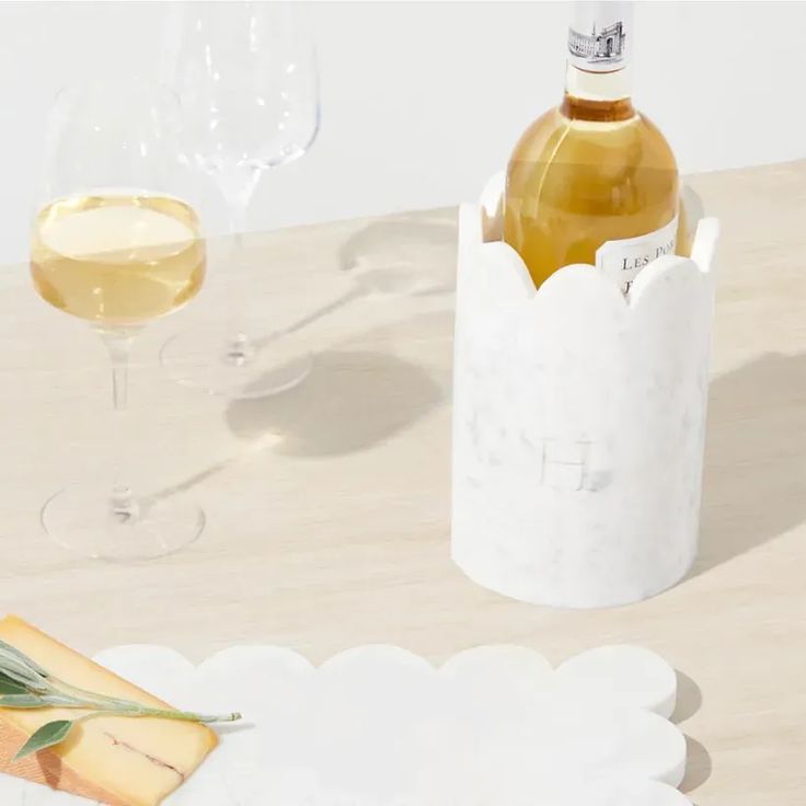 a bottle of wine and cheese on a table