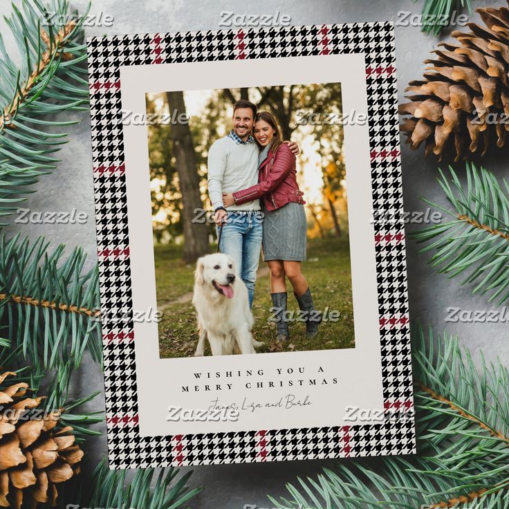 a christmas card with an image of a couple and their dog on it next to pine cones