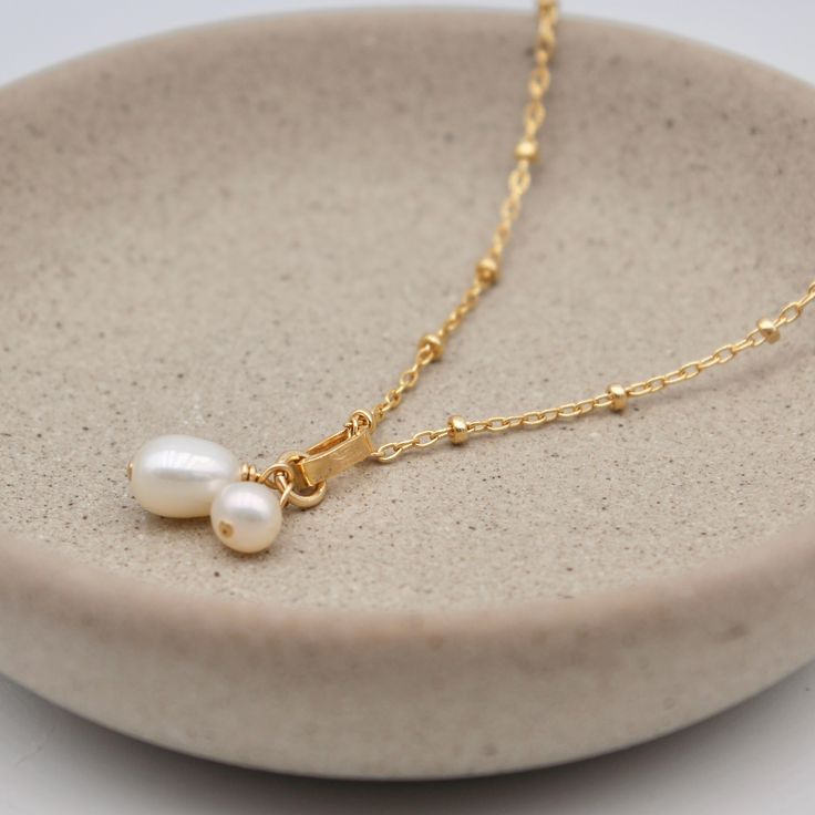 Details: ・14k gold-filled chain + components ・freshwater pearls ・19" chain length Need additional length options? Add-on an extender chain HERE. Delicate 14k Gold Filled Charm Necklaces With Pearl Pendant, Delicate 14k Gold Filled Charm Necklace With Pearl Chain, 14k Gold Filled Pearl Necklace For Gift, Delicate 14k Gold Filled Necklaces With Pearl Charm, Delicate 14k Gold Filled Pearl Necklace With Adjustable Chain, Dainty 14k Gold Filled Charm Necklace With Pearl Pendant, Pearl Cable Chain Necklaces As Gift, Everyday Pearl Charm Necklace With Adjustable Chain, Everyday Pearl Drop Dangle Necklace