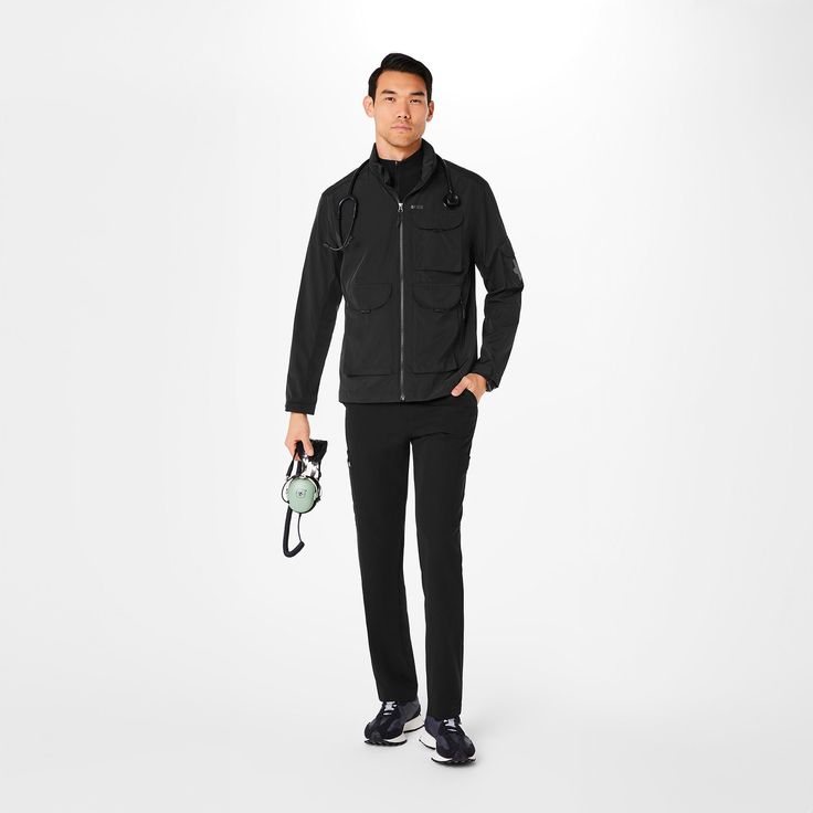 Official FIGS® Outerwear. Get Free Shipping On Orders $50+! | FIGS Mens Black On-Shift Extremes Jacket™ Functional Windproof Sport Coat For Fall, Fall Windproof Functional Sport Coat, Black Outerwear With Functional Pockets For Fall, Black Fall Outerwear With Functional Pockets, Techwear Sport Coat For Outdoor Activities, Sports Outerwear With Functional Pockets, Sports Outerwear With Functional Pockets And Long Sleeves, Functional Sports Outerwear With Multiple Pockets, Black Functional Outerwear With Pockets