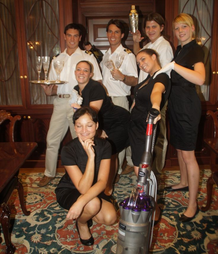 a group of people posing for a photo with a vacuum