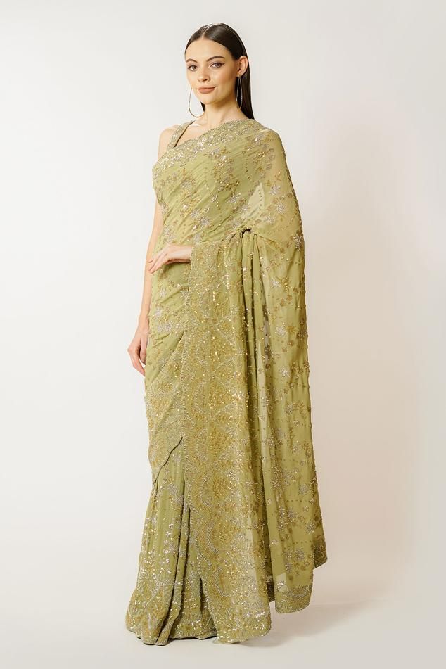 Olive green georgette saree with sequins and cutdana hand embroidery. Comes with a blouse.
Components: 2
Pattern: Hand embroidered
Type Of Work: Sequins, Cutdana
Neckline: Round
Sleeve Type: Sleeveless
Fabric: Georgette
Color: Green
Other Details: 
Closure: Blouse - Back hooks and tie-up
Occasion: Wedding - Aza Fashions Green Georgette Saree, Embroidered Saree, Green Saree, Blouse For Women, Georgette Saree, Green Sequins, Saree With Blouse, Georgette Sarees, Blouse Online