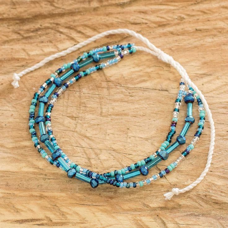 Three delightful cords of crystal and glass beads and tubes come together over a single cotton cord to make a unique wristband bracelet for any occasion. Guatemalan artisan Mirian Zet designs and hand-crafts the adjustable bracelet by meticulously placing each bead one at a time onto nylon cords. Adjustable Multi-strand Turquoise Beaded Bracelets, Blue Adjustable Friendship Bracelets With Round Beads, Blue Beaded Bracelets With Adjustable Cord, Bohemian Blue Beaded Bracelet With Adjustable Cord, Blue Beaded Bracelets With Adjustable Cord For Festival, Blue Heishi Beads Friendship Bracelets For Festivals, Blue Bohemian Beaded Bracelets With Adjustable Length, Bohemian Blue Beaded Bracelets With Adjustable Length, Tiny Bead Bracelet