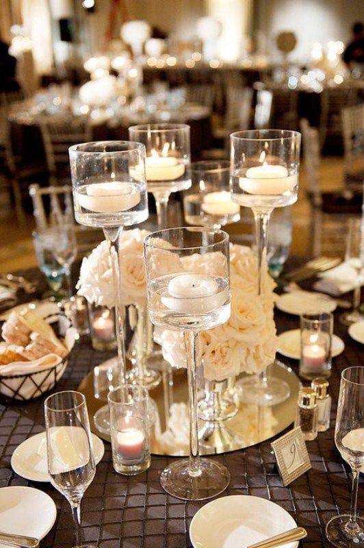 the table is set with wine glasses and candles