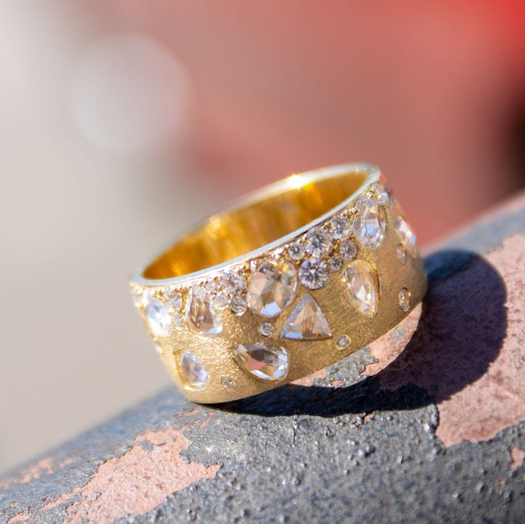 a gold ring sitting on top of a rock