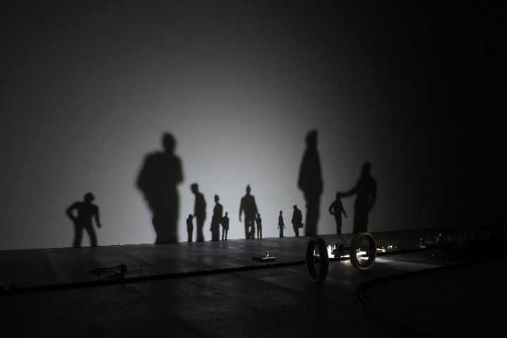 the shadow of people standing in front of a wall