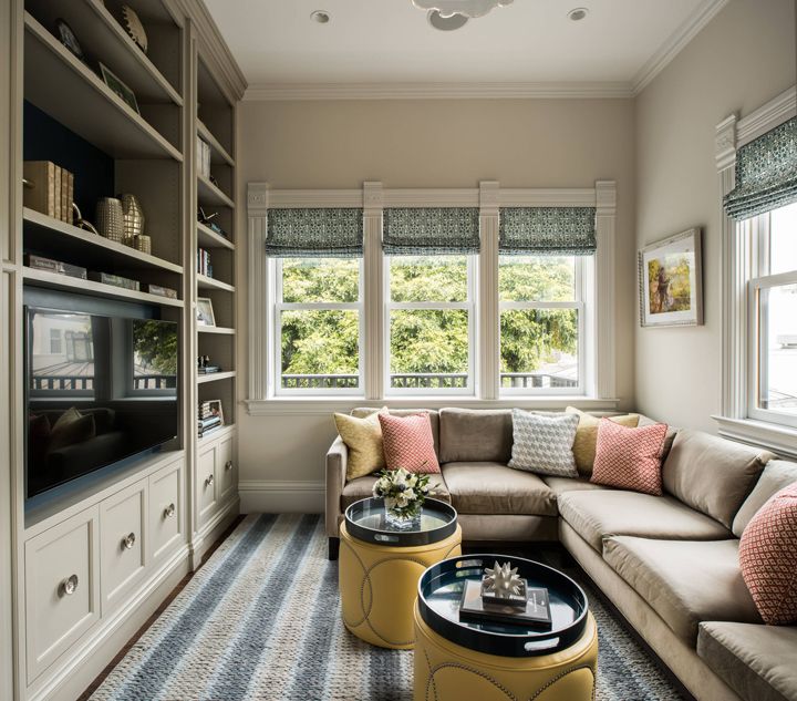 a living room filled with furniture and windows