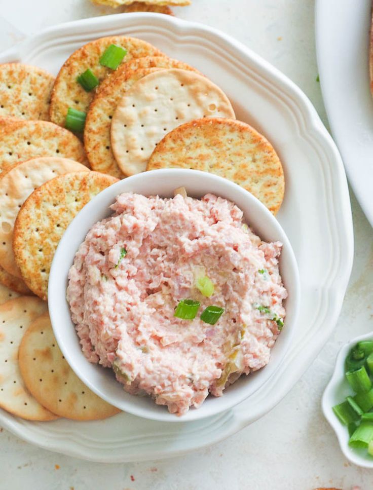 a plate with crackers and dip on it