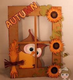 an autumn window with sunflowers on it and the word autumn written in large letters