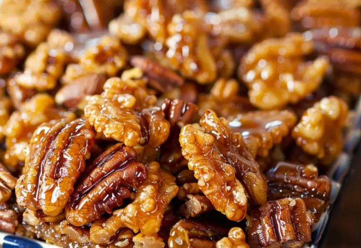 there are pecans and other nuts in the tray together on the table for display