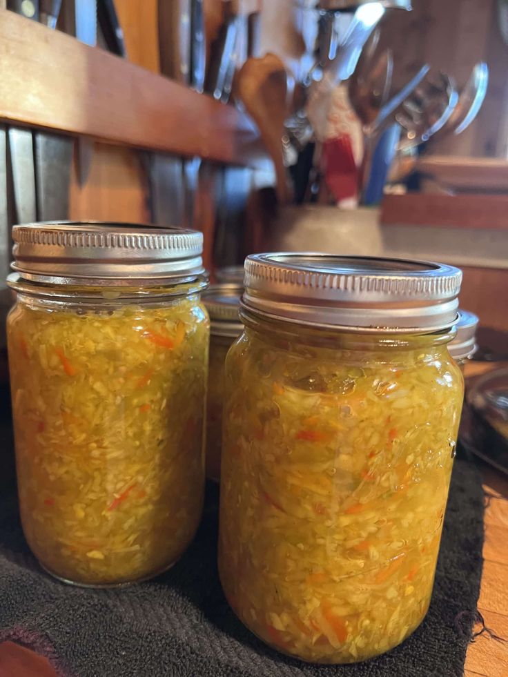 two jars filled with food sitting on top of a table