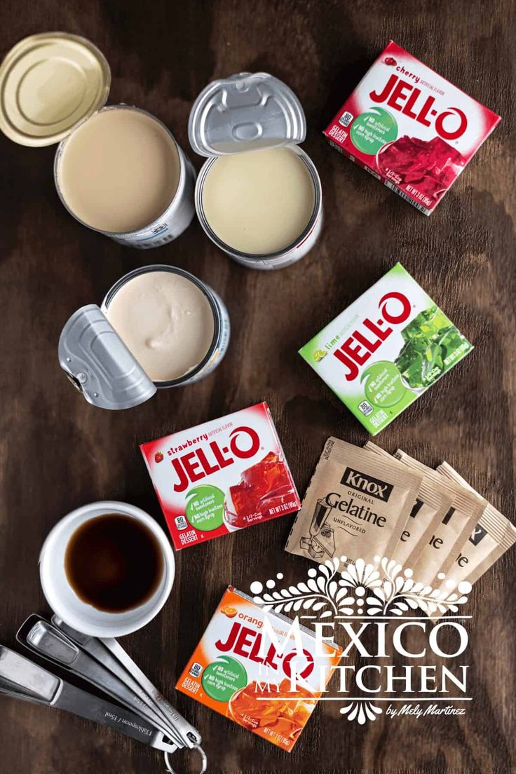 the ingredients to make jello are laid out on top of a wooden table next to cups and spoons