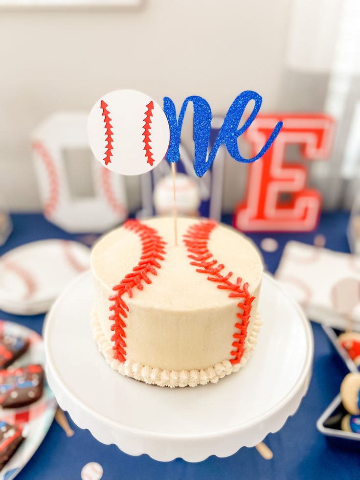 a baseball themed birthday cake with the number one on top