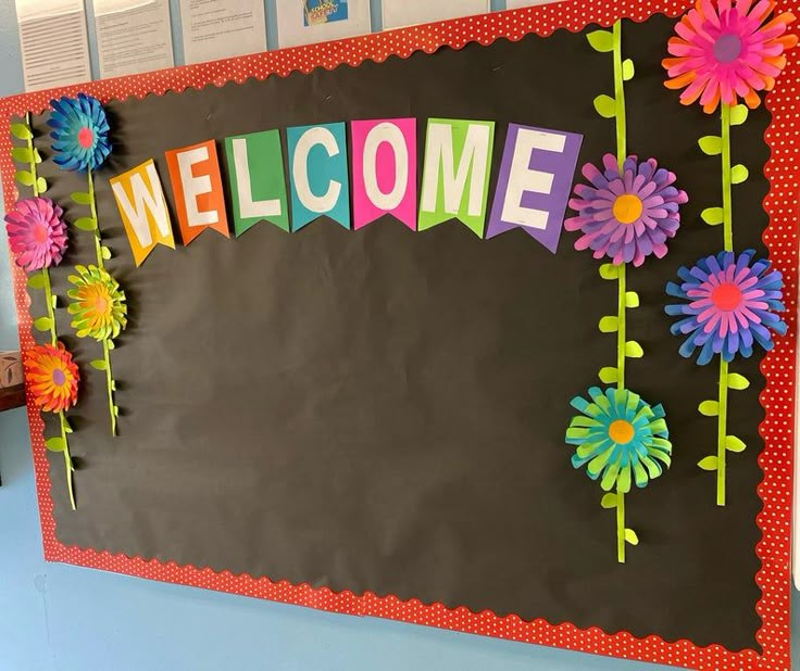 a bulletin board decorated with flowers and the word welcome