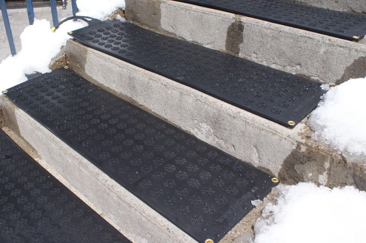 the steps are covered with snow and have black treads