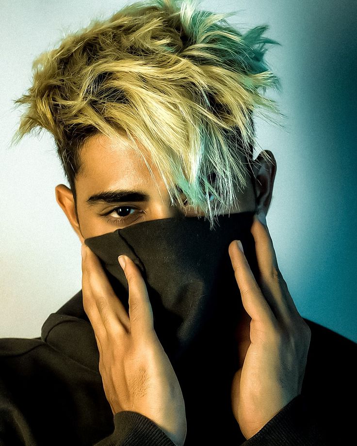 a man with blonde hair covering his face