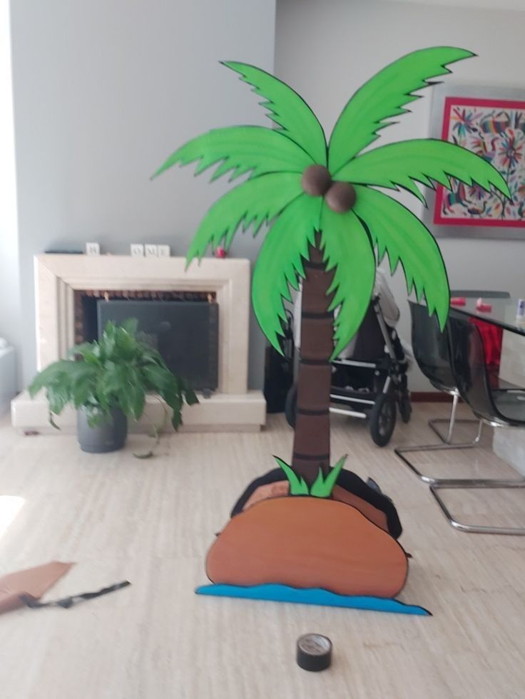 a paper palm tree sitting on top of a wooden table