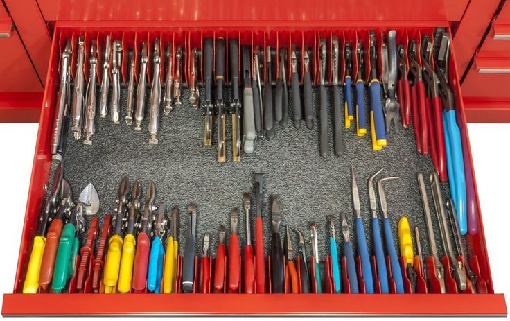 a red toolbox filled with lots of different types of screwdrives and tools