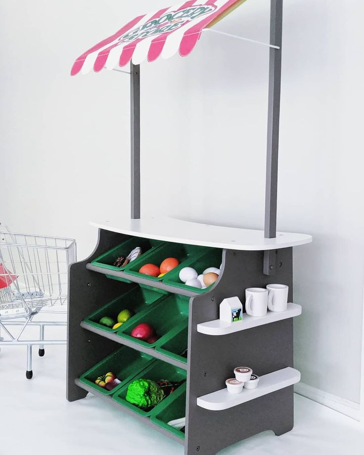 a food cart with an umbrella over it in a room next to a shopping cart