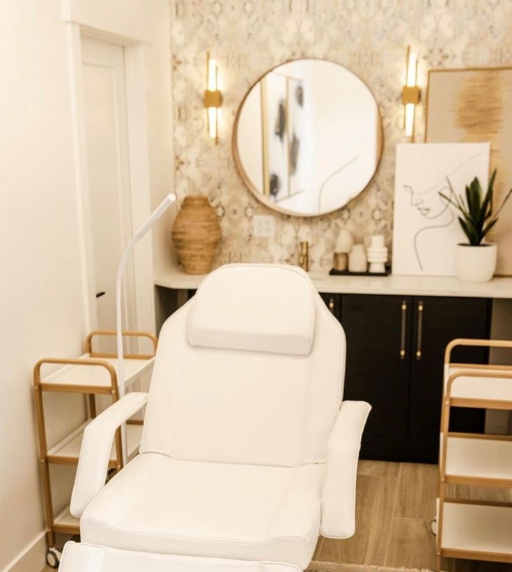 a white reclining chair sitting in front of a mirror