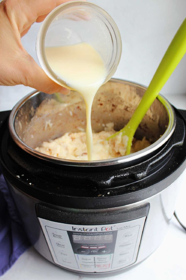 someone pouring milk into an instant pot filled with rice