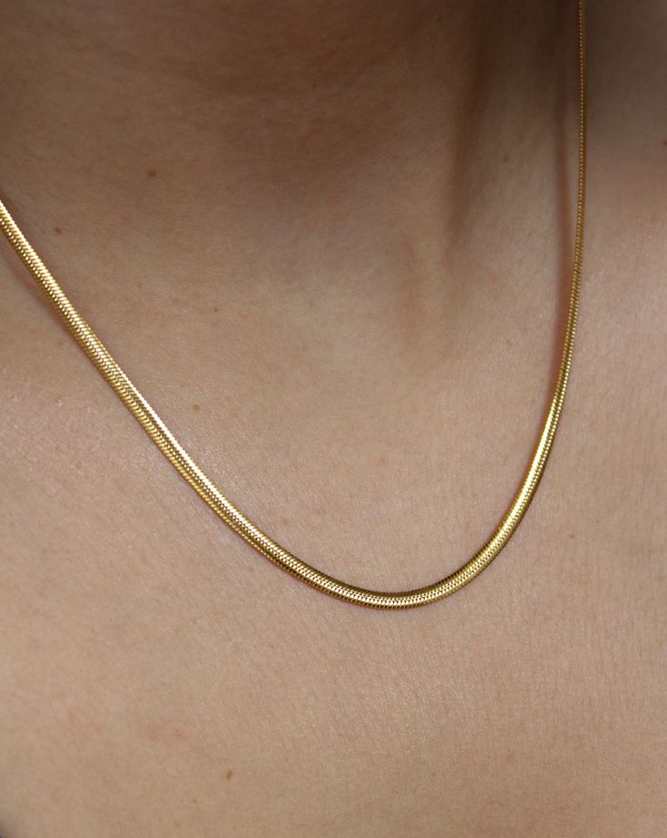 This 18K gold plated SLINKY ESSENTIAL CHAIN is the perfect addition to your everyday wardrobe. Made of high-quality stainless steel, this chain is durable and versatile, making it suitable just any occasion. It's an essential piece that will layer perfectly with any other chain or pendant necklace . Minimalist Yellow Gold Stainless Steel Chain Necklace, Stainless Steel Tarnish Resistant Snake Chain Necklace, Stainless Steel Tarnish-resistant Snake Chain Necklace, Gold Delicate Chain Stainless Steel Necklace, Gold Stainless Steel Delicate Chain Necklace, Gold Delicate Stainless Steel Chain Necklace, Minimalist Gold Stainless Steel Chain Necklace, Gold Plated Snake Chain Necklace For Everyday, Everyday Gold Plated Snake Chain Necklace