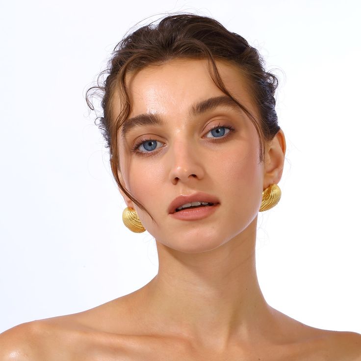 Discover the allure of our gold-plated seashell earrings, exquisitely crafted to capture the essence of the ocean's natural beauty. They feature delicate details and a lustrous finish, offering a timeless elegance that complements any outfit. Perfect for both casual and formal occasions, these earrings are a statement of sophisticated style and coastal charm. Handcrafted with 24k Gold plated brass Nickel, lead and cadmium free Earring pins are made of gold plated 925 silver which are non-allerge Gold-plated Shell-shaped Earrings, Gold Plated Shell-shaped Earrings, Single Shell-shaped Gold Earring, Elegant Round Beach Earrings, Elegant Gold Plated Shell Jewelry, Elegant Gold-tone Jewelry For Beach, Elegant Gold-tone Beach Jewelry, Gold Shell-shaped Hoop Earrings, Gold Shell-shaped Hoop Earrings For Pierced Ears