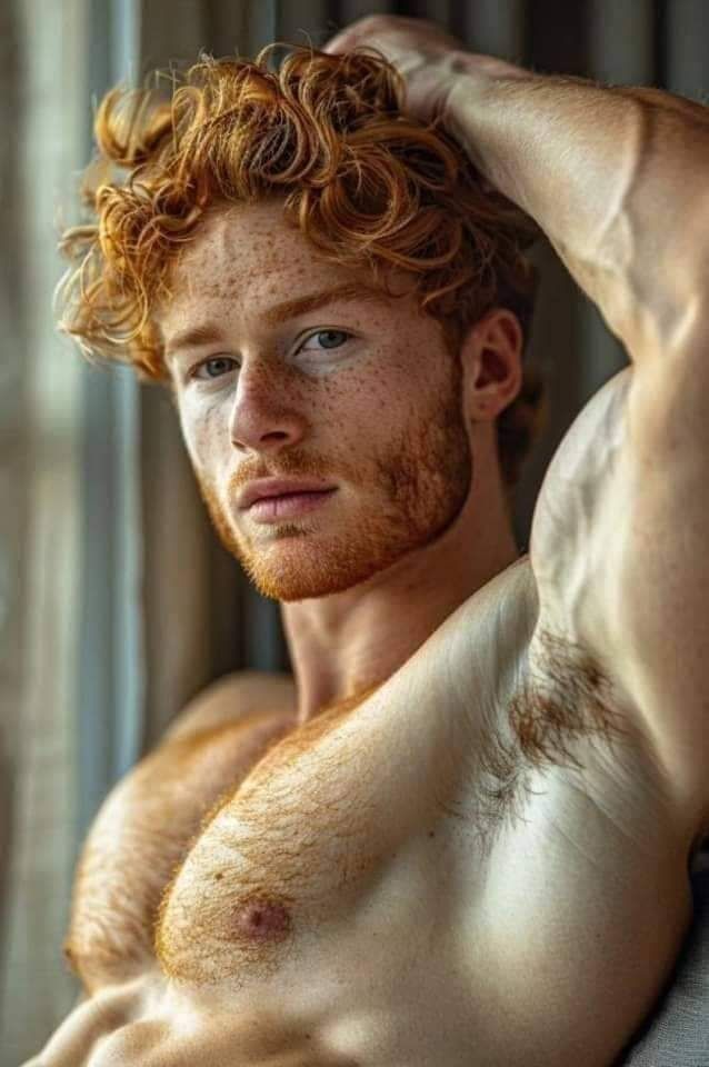 a young man with red hair and freckles on his body is posing for the camera