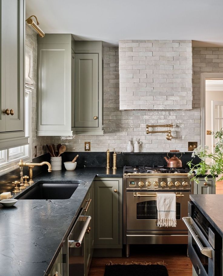 a kitchen with an oven, sink and stove top in it's center island