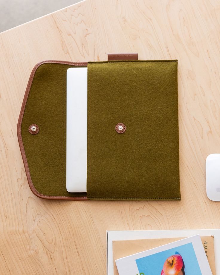 To protect our most valued technology we decided to look to the elegant folios of the past. Large envelope clutches were the most sophisticated way to carry documents and papers to meetings. Reimagined as stylish laptop sleeves and tech accessory pouches, the vibrant merino wool protects from damage while the vintage-inspired leather edge binding gives structure and elegance to the devices we use every day.

 Fits 14" laptops.

  

 Benefits of Merino Wool Felt

  
 * Sustainable, biodegradable, Travel Envelope Bag With Laptop Sleeve, Rectangular Workwear Cases With Laptop Sleeve, Modern Laptop Sleeve Case, Wine Carrier Bag, Day Fits, Wine Markers, Large Envelope, Wine Carrier, Computer Sleeve