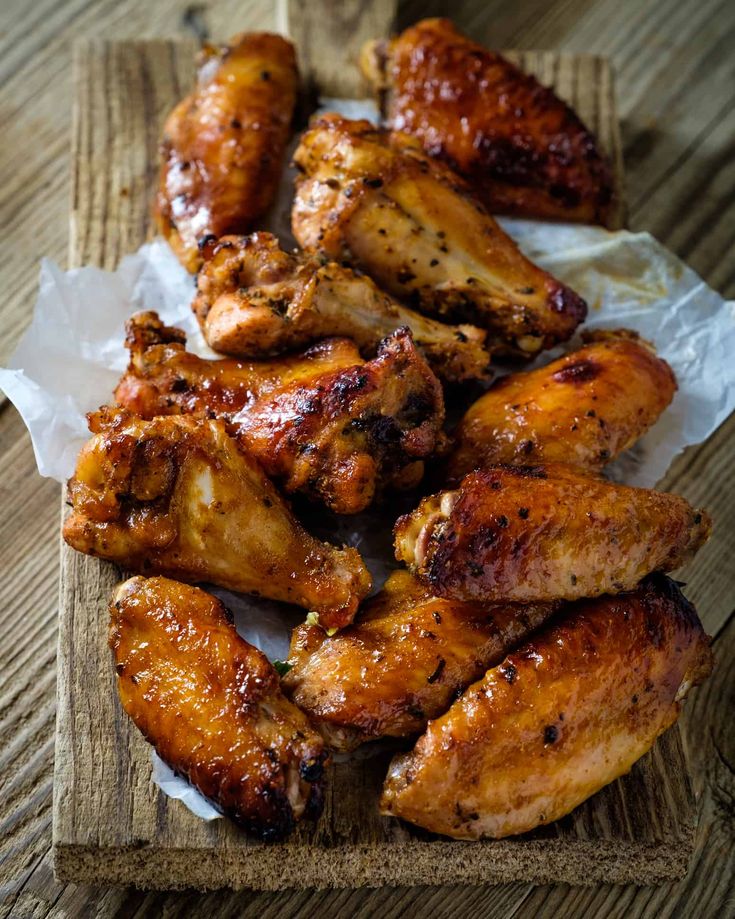 some chicken wings are on a cutting board